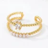 Vergulde ring met edelstenen en parels